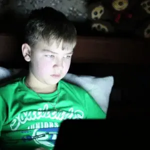 teenager in a dark room on computer nynerds x